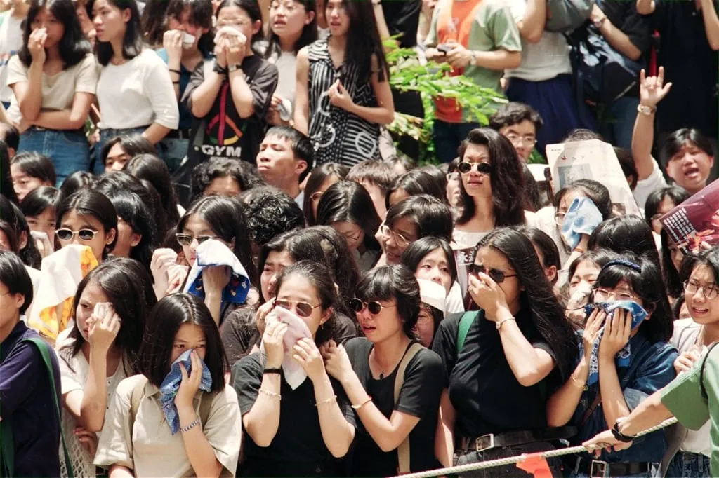 Distraught teenage fans gather to say goodbye to Wong at his funeral.