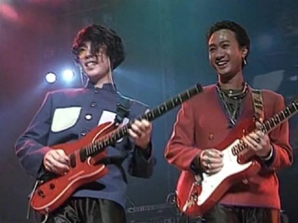 Wong Ka-kui (right) plays his red and white Fender Stratocaster, the guitar with which he was most closely associated.