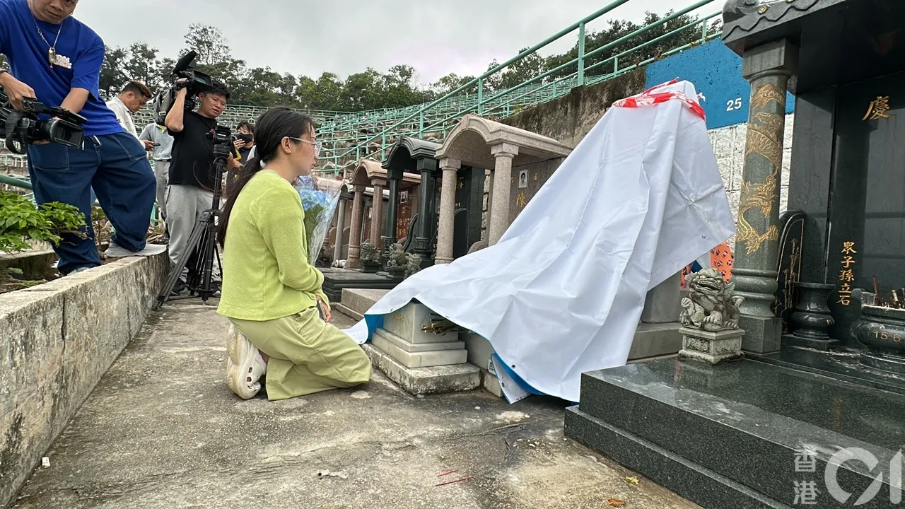 由四川來港的阿英，驚悉偶像填墓被毀，手持鮮花跑地致祭，泣不成聲。（馬耀文攝）